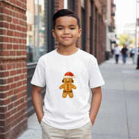 Load image into Gallery viewer, Child wearing a white t-shirt with a gingerbread man design on a city street.
