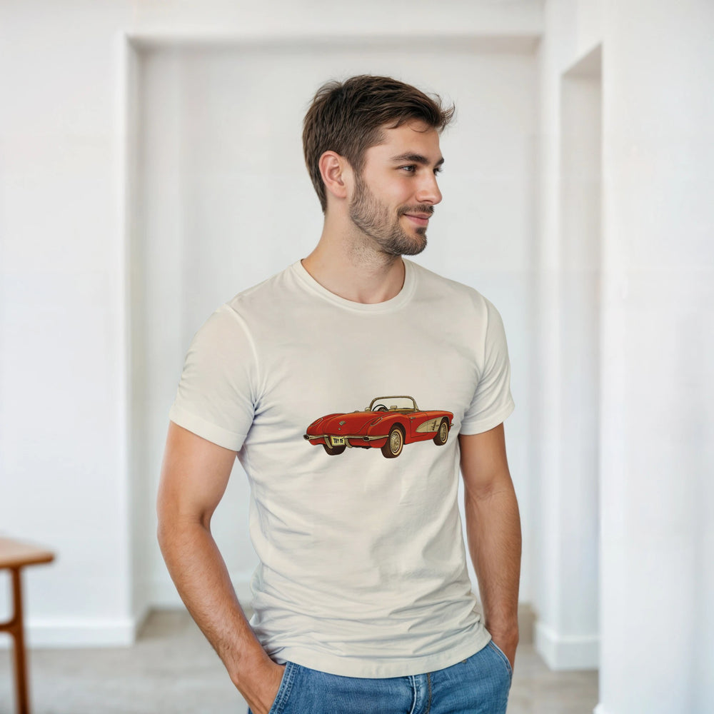 Man wearing a beige t-shirt with a red car graphic in a minimalistic room.