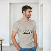 Load image into Gallery viewer, Man wearing a beige t-shirt with a car graphic in a minimalistic room.
