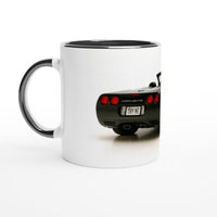 Load image into Gallery viewer, White mug with black interior and handle featuring a Corvette car design on a white background
