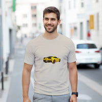 Load image into Gallery viewer, Man wearing a t-shirt with a yellow car graphic on a city street
