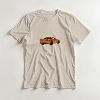 Load image into Gallery viewer, Beige t-shirt with an orange car graphic on a white background
