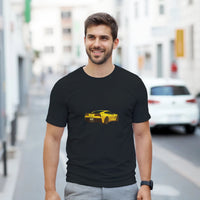 Load image into Gallery viewer, Man wearing a black t-shirt with a yellow car graphic on a city street.
