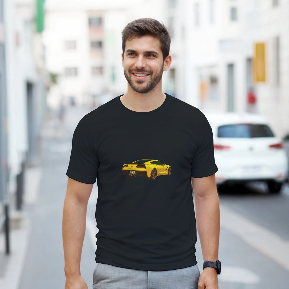 Man wearing a black t-shirt with a yellow car graphic on a city street.