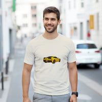 Load image into Gallery viewer, Man wearing a white t-shirt with a yellow car graphic on a city street.
