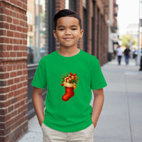 Load image into Gallery viewer, Child wearing a green t-shirt with a Christmas stocking design on a city street.
