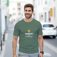 Load image into Gallery viewer, Man wearing a green t-shirt with &#39;MINDSET IS Everything&#39; text on a city street background
