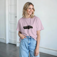 Load image into Gallery viewer, Woman wearing a pink t-shirt with a car graphic and light blue jeans indoors.
