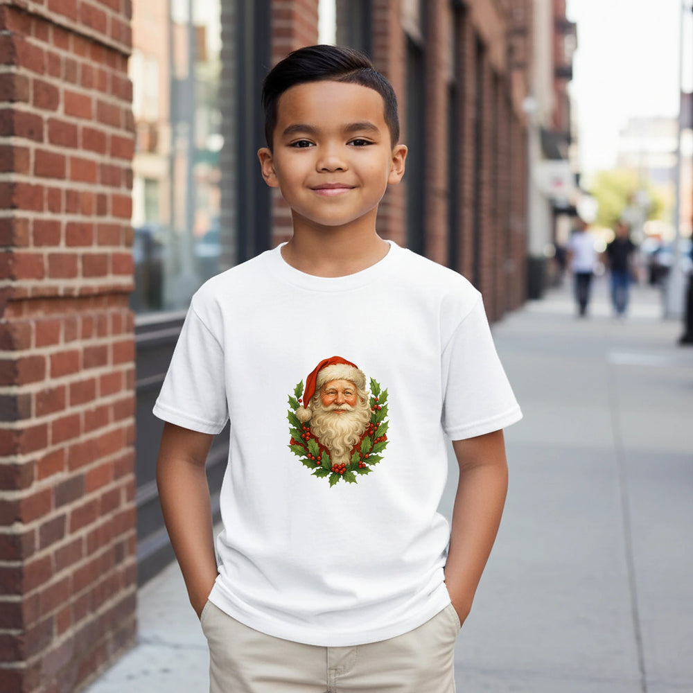 Child wearing a white t-shirt with a Santa Claus design on a city street.