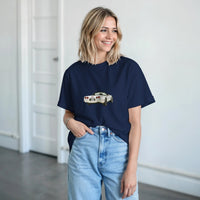 Load image into Gallery viewer, Woman wearing a navy blue t-shirt with a graphic design, standing indoors.
