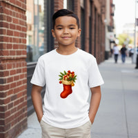 Load image into Gallery viewer, Child wearing a white t-shirt with a Christmas stocking design on a city street.
