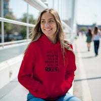 Load image into Gallery viewer, Person wearing a red hoodie with text, sitting outdoors on a sunny day.
