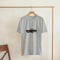 Load image into Gallery viewer, Gray t-shirt with a car graphic on a wooden hanger against a beige wall.
