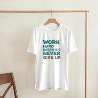 Load image into Gallery viewer, White t-shirt with motivational text on a wooden hanger against a plain wall.
