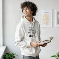 Load image into Gallery viewer, Person wearing a white hoodie with text, holding a book in a room with plants and framed pictures.
