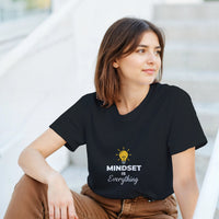 Load image into Gallery viewer, Woman wearing a black t-shirt with &#39;MINDSET is Everything&#39; text and light bulb graphic.
