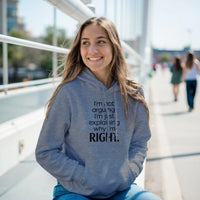 Load image into Gallery viewer, Woman wearing a blue hoodie with text, sitting outdoors on a sunny day.

