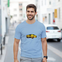 Load image into Gallery viewer, Man wearing a light blue t-shirt with a yellow car graphic on a city street.
