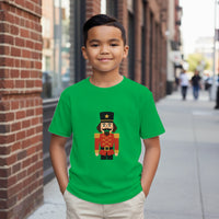 Load image into Gallery viewer, Child wearing a green t-shirt with a toy soldier design on a city street.
