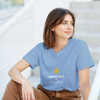 Load image into Gallery viewer, Woman wearing a blue t-shirt with &#39;MINDSET is Everything&#39; text and logo.

