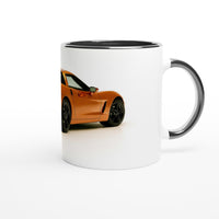 Load image into Gallery viewer, White mug with a black interior and handle featuring an orange car design on a white background
