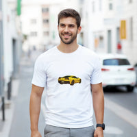 Load image into Gallery viewer, Man wearing a white t-shirt with a yellow car graphic on a city street.
