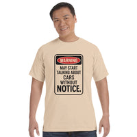 Load image into Gallery viewer, Man wearing a beige t-shirt with a humorous warning sign design on a white background
