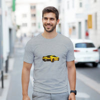 Load image into Gallery viewer, Man wearing a gray t-shirt with a yellow car graphic on a city street.
