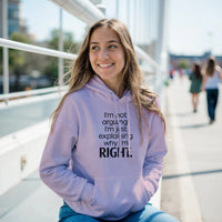 Load image into Gallery viewer, Woman wearing a lavender hoodie with text, sitting outdoors on a sunny day.
